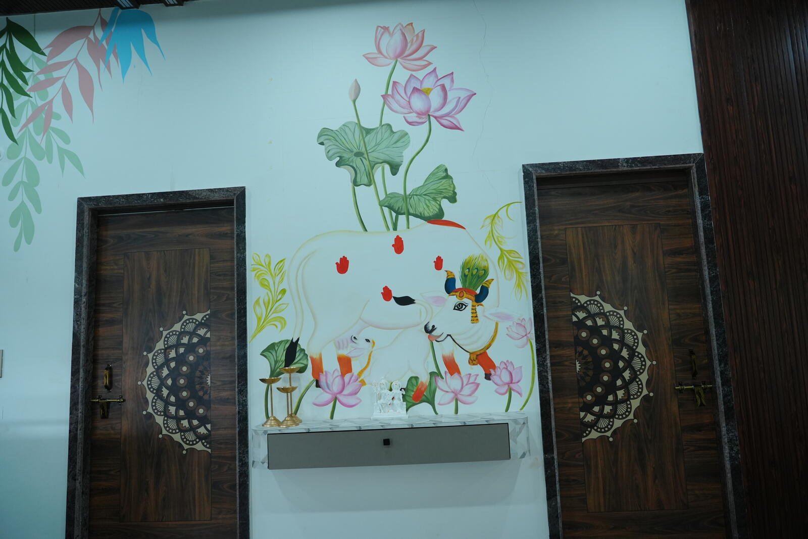 Hand-painted Lord Krishna and sacred cow mural at LP Nature Nest